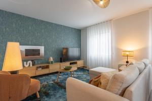a living room with a couch and a tv at Cozy Haven Santana - Nature & Hiking Trails in Santana