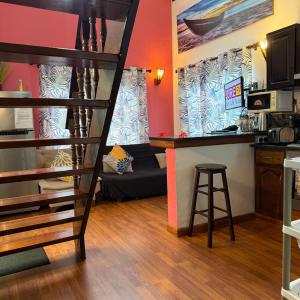 a living room with a bunk bed and a kitchen at Mer Riviere Self Catering Apartment in Beau Vallon