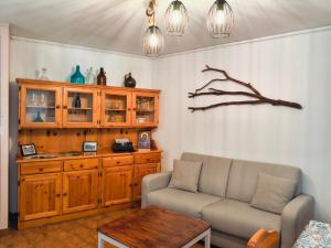 a living room with a couch and a table at Casa Pal Piccolo - Apartment with garage for bikes and fast wifi in Paluzza +13 photos