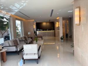 a lobby with couches and chairs and a bar at منازل التوت للشقق المخدومة القيم in Taif
