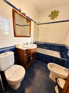 a bathroom with a toilet and a sink and a tub at Posada El Valle - Adults Only in Suances +27 photos