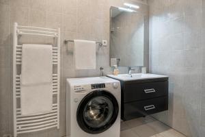 a bathroom with a washing machine and a sink at Prostorni in udobni apartmaji Izola SL - Spacious & Comfortable Apartments Izola SL in Izola +28 photos