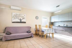 a living room with a couch and a table at Prostorni in udobni apartmaji Izola SL - Spacious & Comfortable Apartments Izola SL in Izola