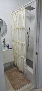 a bathroom with a shower with a shower curtain at Martha's House Audi in Soufrière