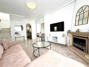 a living room with a couch and a fireplace at Villa Emika with private pool in Ciudad Quesada in Ciudad Quesada