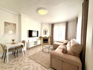 a living room with a couch and a table at Villa Emika with private pool in Ciudad Quesada in Ciudad Quesada