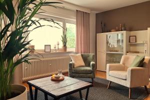 a living room with two chairs and a table at Happywild in Schlangenbad