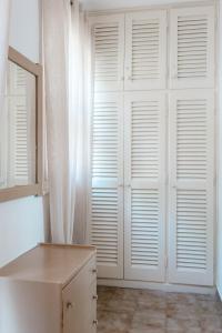 a room with white closet doors with a window at Corfu Dream Holidays Villas in Glyfada