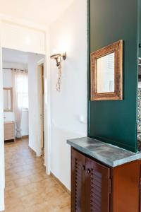 a bathroom with a mirror on a green wall at Corfu Dream Holidays Villas in Glyfada +55 photos