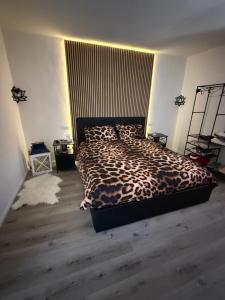 a bedroom with a leopard print bed in a room at Casa Belvedere in Serradica
