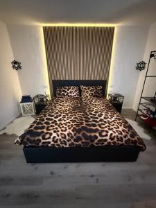 a bedroom with a leopard print bed in a room at Casa Belvedere in Serradica