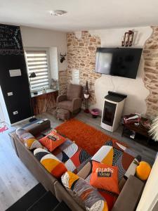 a living room with a couch and a flat screen tv at Casa Belvedere in Serradica