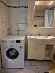 a bathroom with a washing machine and a sink at Blue studio in Kavála