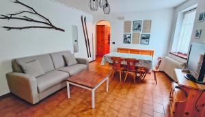 a living room with a couch and a table at Casa Pal Piccolo - Apartment with garage for bikes and fast wifi in Paluzza