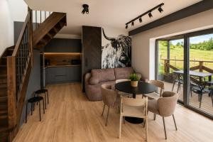 a living room with a table and a couch at D'Pazur- sauna, jacuzzi in Białka Tatrzańska