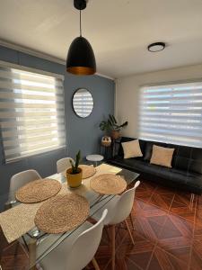 a living room with a table and chairs and a couch at Casa 2 dormitorios - Punta Arenas - Río Seco in Punta Arenas
