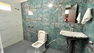 a bathroom with a sink and a toilet at Sunrise Prime in Kānke