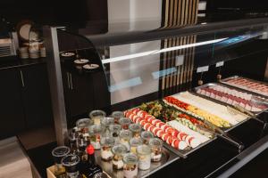 a buffet with sushi and other food on a table at ART Hotel Grenzach-Wyhlen bei Basel in Grenzach-Wyhlen +33 photos