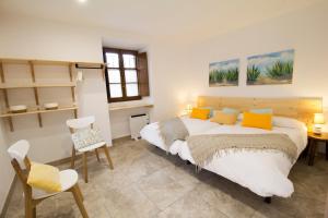 a bedroom with a large bed and a table and chairs at Tailer-Txiki in Apatamonasterio