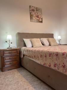 a bedroom with a bed and a nightstand with two lamps at Marina's House in Gaios