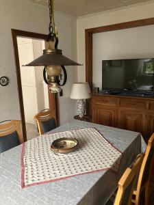 a dining room table with a plate on top of it at Haus Eichholz in Tellingstedt