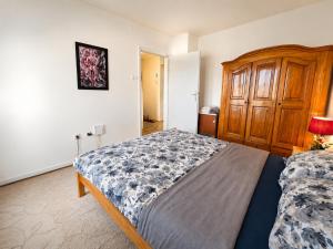a bedroom with a bed and a wooden cabinet at Abrazo in Orašje