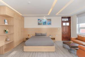 a bedroom with a bed and a couch at Nha Trang Center Point in Nha Trang