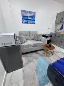 a living room with a couch and a table at Peace Nest bamburi in Mombasa