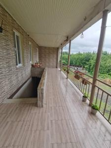 a porch with a wooden bench on a building at Фазенда Оганеса in Ureki +7 photos