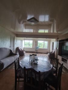a living room with a table and a couch at Фазенда Оганеса in Ureki