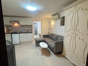 a living room with a couch and a table at Tranquil garden hideaway in Gozo in San Lawrenz +14 photos