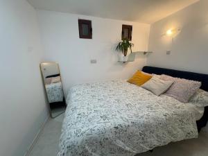 a bedroom with a bed and a mirror at Tranquil garden hideaway in Gozo in San Lawrenz