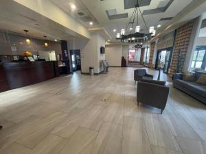 a large lobby with a couch and chairs in a building at FairBridge Inn & Suites Independence in Cleveland