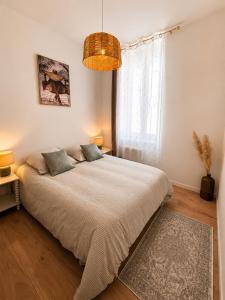 a bedroom with a large bed and a window at Terrasse - CLIM - Arènes à pied - 4 pers in Nîmes