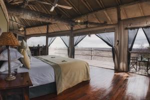 a bedroom in a safari tent with a bed at Tarangire Treetops in Kwa Kuchinia