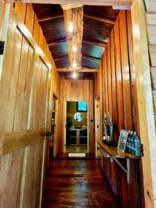 a hallway with wood paneling and a hallway with a door at Khao Sok Silver Cliff Resort in Khao Sok National Park