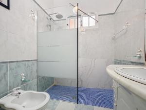 a bathroom with a shower and a toilet and a sink at Casa Moreira by AH in Caniçal +17 photos