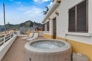 a hot tub on the balcony of a house at Casa Moreira by AH in Caniçal