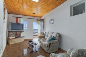 a living room with a couch and a tv at Casa Moreira by AH in Caniçal