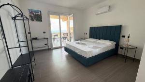 a bedroom with a bed and a view of the ocean at Torre Antica in Ioppolo