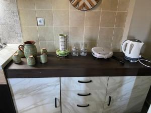 a counter in a kitchen with a coffee maker on it at Villa J&C-SAINT AIMILIANOS in Porto Heli