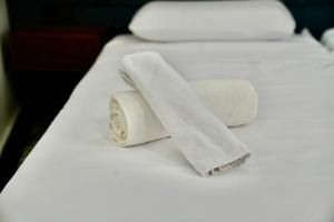 two rolls of towels sitting on a bed at Riad Chouara in Fez +86 photos
