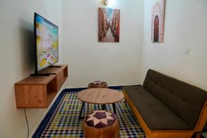 a living room with a couch and a table at Riad Chouara in Fez