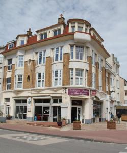 a large building on the corner of a street at Verborgen Pareltje in Bray-Dunes