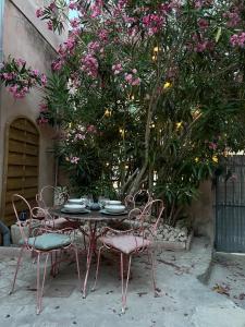 a table and chairs in a garden with flowers at Villecroze 1 in Villecroze