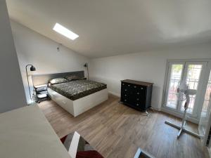 a bedroom with a bed and a dresser and window at Villecroze 1 in Villecroze