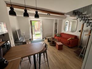 a living room with a red couch and a table at Villecroze 1 in Villecroze