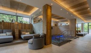 a living room with a couch and a staircase in a house at Wellings Parkhotel in Kamp-Lintfort +97 photos