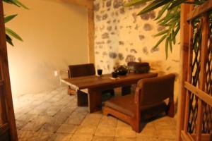 a dining room with a wooden table and chairs at Kokoro Lagoon in Saint-André-de-Sangonis