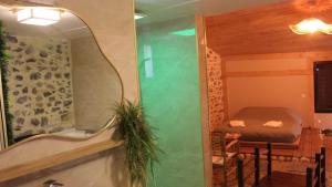 a bathroom with a tub and a mirror and a bed at Kokoro Lagoon in Saint-André-de-Sangonis